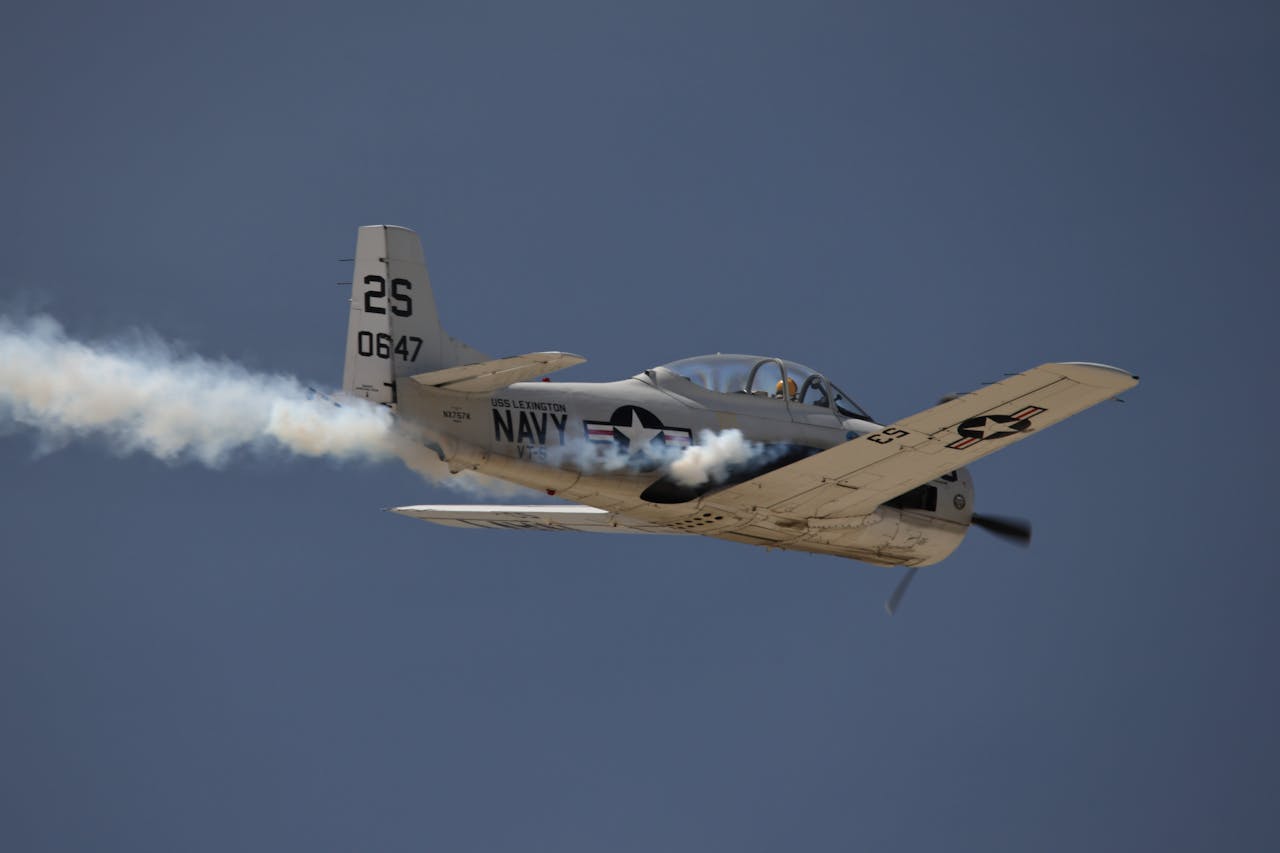 gallery-3 A vintage military aircraft performing aerobatics at March Air Reserve Base airshow.